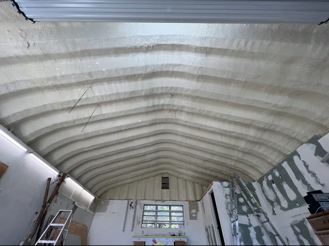 Spray polyurethane foam applied to the underside of a metal roof deck in Portage
